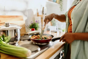 Woman cooking meal prep in kitchen